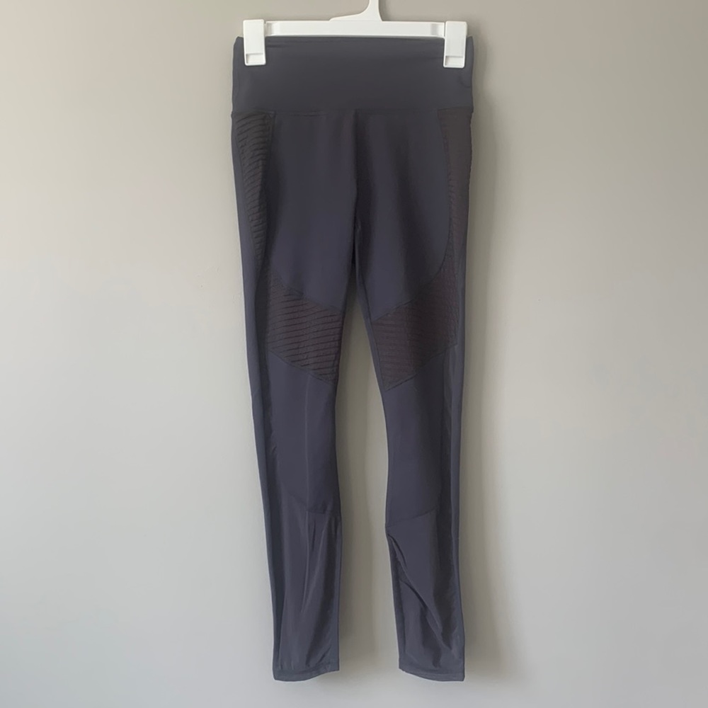 Fabletics dark purple leggings with mesh detailing around the ankles